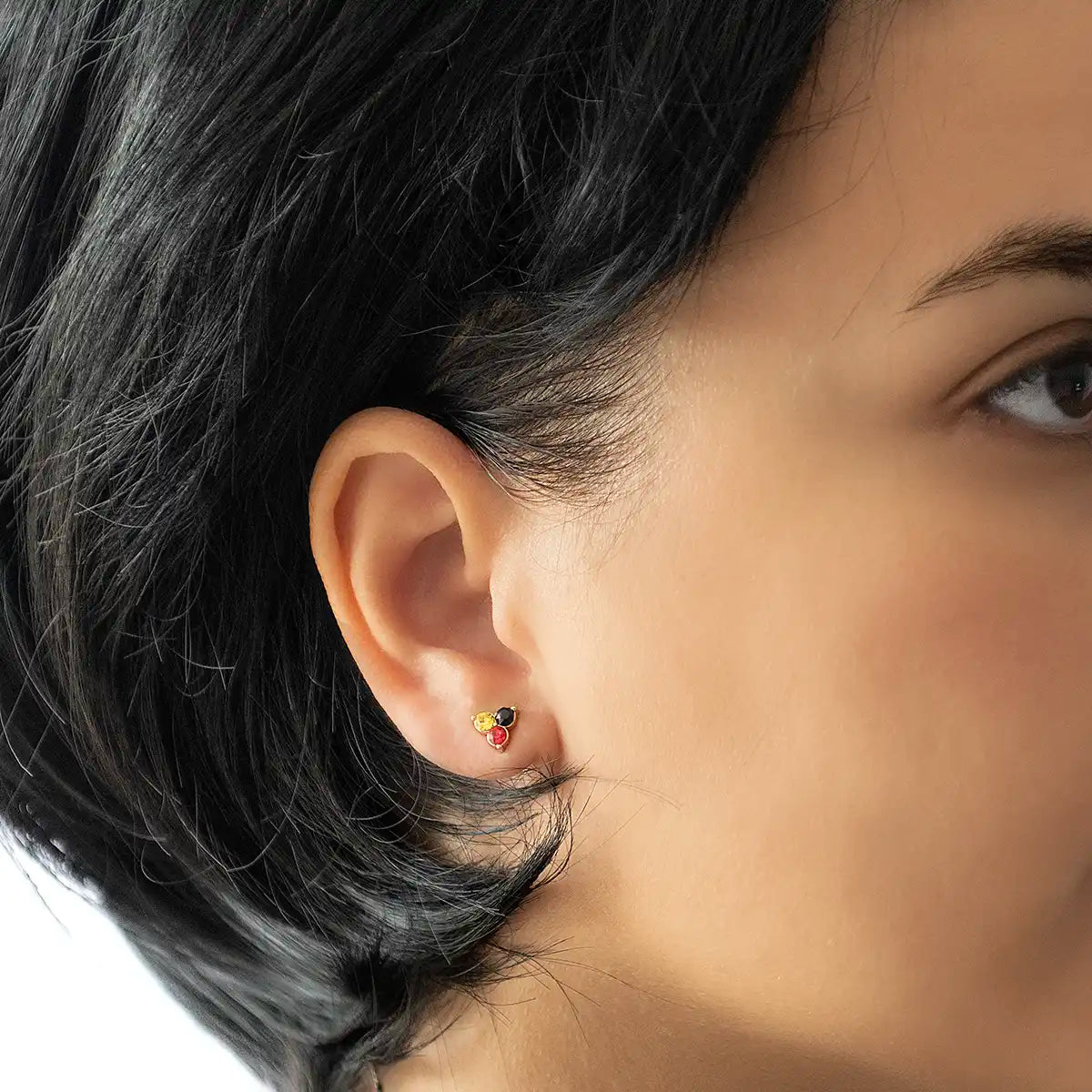 Close up of Aboriginal Flag Stud Earrings on Aboriginal woman