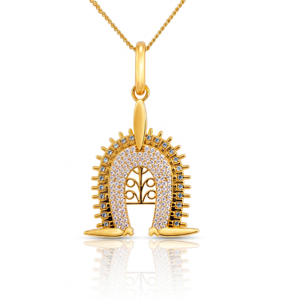 Torres Strait Island Gold-plated Dhoeri Headdress pendant necklace adorned with pave-set clear stones and small blue accent stones, suspended from a gold chain on a white background with a soft reflection.